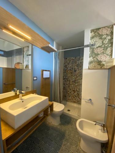 a bathroom with a sink and a toilet at Villa Borgo Musolino in Messina