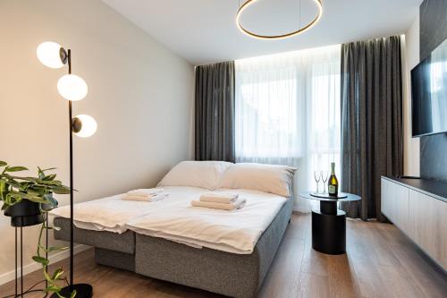 a bedroom with a bed and a large window at MCK Apartments in Košice