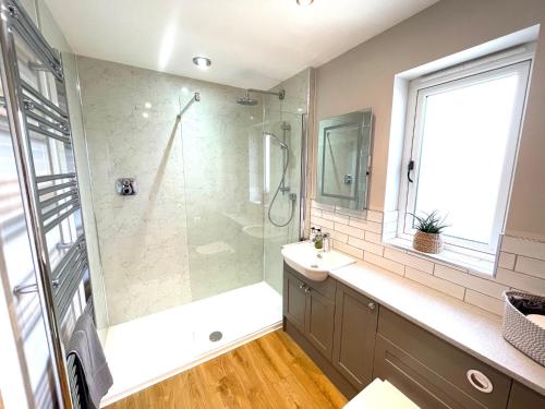 a bathroom with a shower and a sink at The Hayloft in Calne