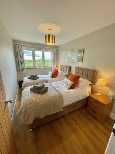 a bedroom with two beds and a window at The Hayloft in Calne