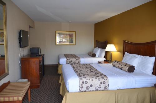 a hotel room with two beds and a television at Regency Inn in Chickasha