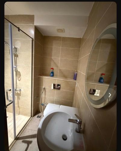 a bathroom with a toilet and a shower and a sink at Studio Alamein towers in El Alamein