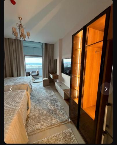 a hotel room with a bed and a television at Studio Alamein towers in El Alamein