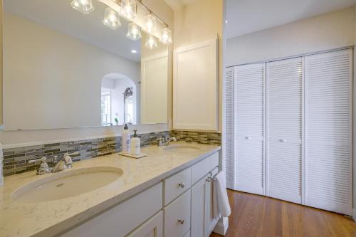 a bathroom with two sinks and a large mirror at Charming Waterfront Home with Mt Rainier View in Olympia
