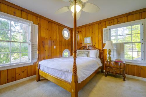 a bedroom with a bed and two windows at Charming Waterfront Home with Mt Rainier View in Olympia