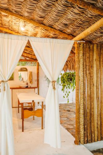 a room with a tent with a table in it at Preá Kite House in Prea