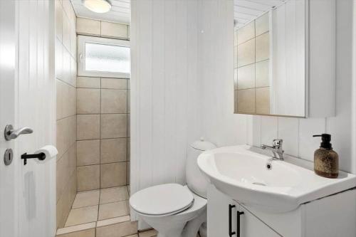 a white bathroom with a toilet and a sink at LF16127-Logstor-Amandasvej-27 in Trend