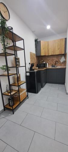 a room with a kitchen with a clock on the wall at Alex House in Făgăraş