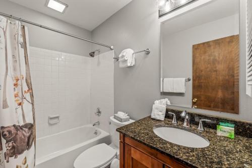 a bathroom with a sink and a tub and a toilet at Mustang in Clark