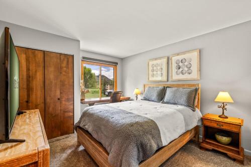 a bedroom with a bed and a flat screen tv at Mustang in Clark
