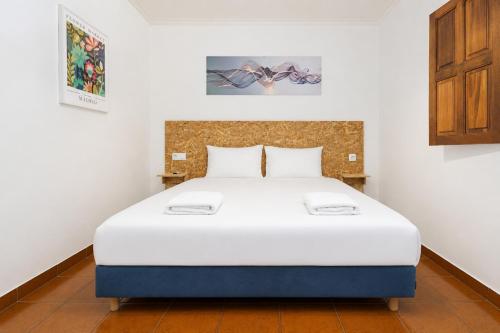 a bedroom with a large bed in a room at Quinta de Carvalhal - Casa da Vinha in Guimarães