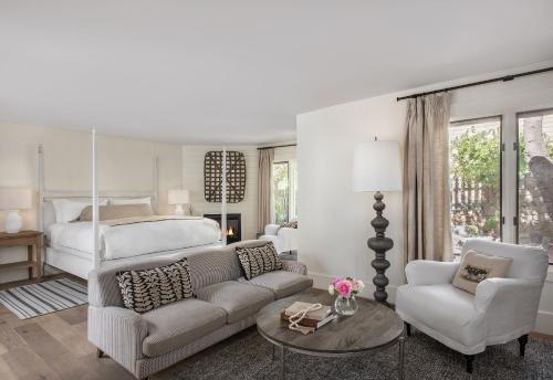 a bedroom with a bed and a couch and a table at Farmhouse Inn in Forestville