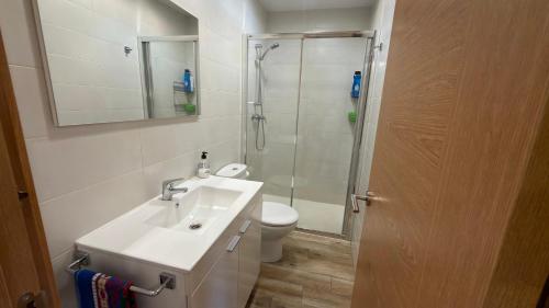 a bathroom with a toilet and a sink and a shower at Casa Entre Riscos in Corejido