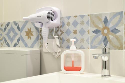a bathroom with a blow dryer on a sink at 100 Passi dal Porto in Civitavecchia