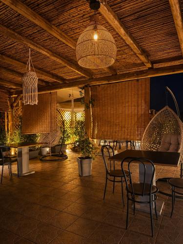 a dining room with a table and chairs and lights at Kokkala Guestrooms in Kokkala
