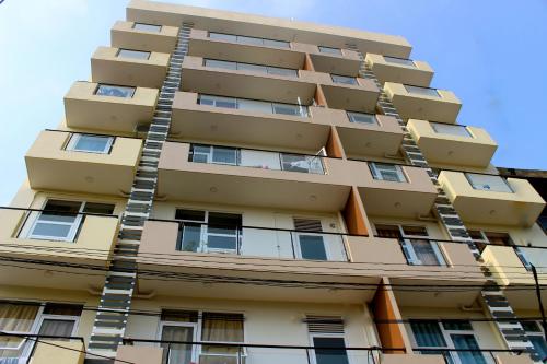 a tall apartment building with a ladder at Mount Princess in Mount Lavinia