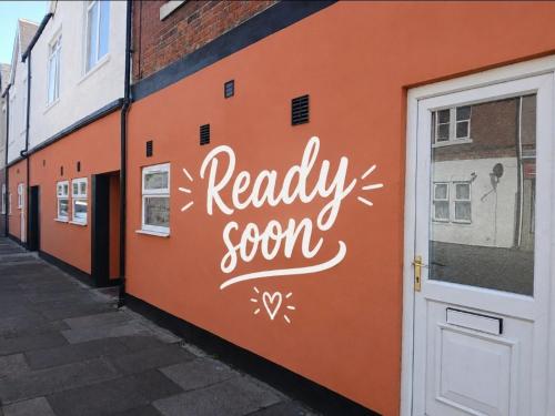 a building with a sign that says ready soon on it at The Ashington Collection in Ashington