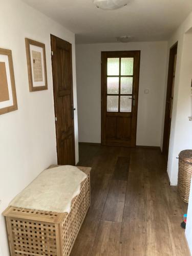 a room with a bed and a wooden door at Chalupa Na konci Lhoty in Pluhův Žďár
