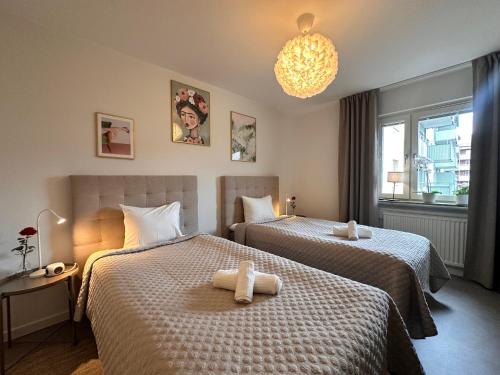 a hotel room with two beds with towels on them at Prinshöjden Apartments - Katrineholm Central in Katrineholm