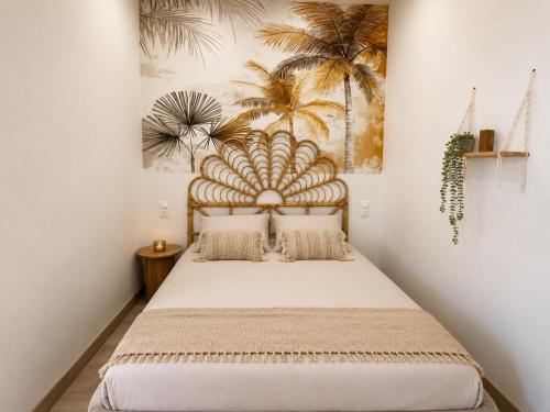 a bedroom with a bed with a mural of palm trees at Eaux Spa Rive Droite in Rouen