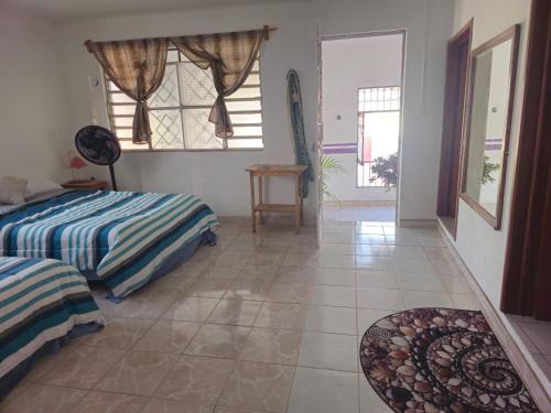 a bedroom with two beds and a tiled floor at Casa el Monte in Valladolid