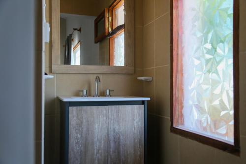 a bathroom with a sink and a mirror at Buenas Vibras Hostería Rural in Chicoana
