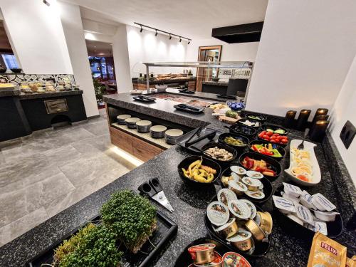 a buffet line with many different types of food at Hotel Lärchenhof in Kaunertal