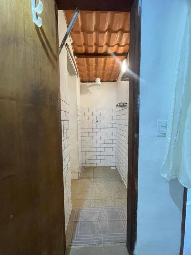 a bathroom with a walk in shower next to a wall at Mirante Morere in Moreré
