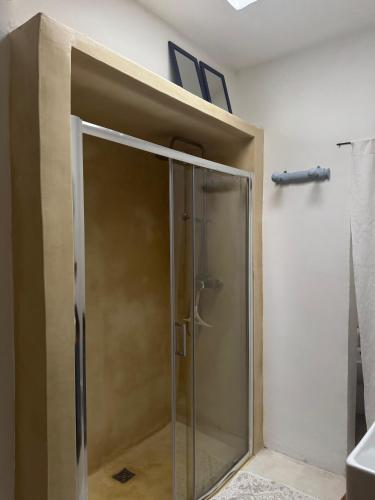 a shower with a glass door in a bathroom at Ca Salentu in Galatone