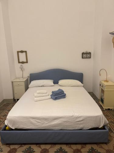 a bed with towels on it in a bedroom at Ca Salentu in Galatone