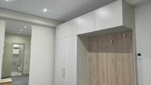 a bathroom with a wooden door on the wall at Тынчтык Отель in Chon-Sary-Oy