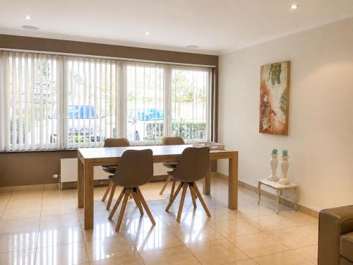 a dining room with a wooden table and chairs at apartment 2 miles from Maastricht in Lanaken