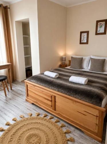 a bedroom with a large bed with two pillows at Willa Wojciechówka in Kościelisko