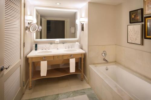 a bathroom with a sink and a tub and a mirror at Hilton Lake Las Vegas Resort & Spa in Las Vegas