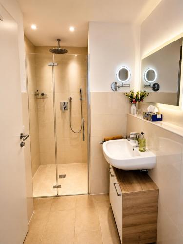 a bathroom with a sink and a shower at Panoramablick mit Premium-Wanderwegen vor der Haustür in Albstadt