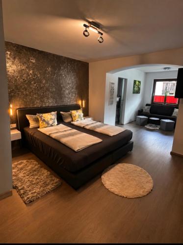 a bedroom with a large bed and a living room at Appartement Wanneck in Biberwier