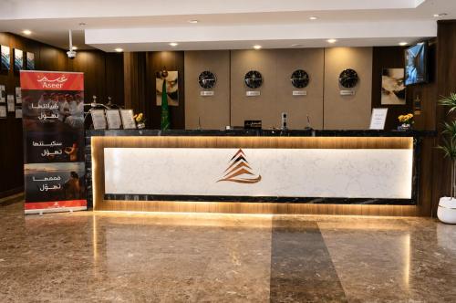 a store lobby with a counter with a sign on it at فندق امان أبها - المحالة in Abha