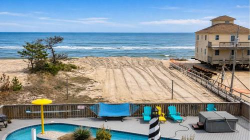 a view of a beach with a playground and a building at Rio Rodanthe Lazy River Kiddie Pool Oceanfront Elevator in Rodanthe