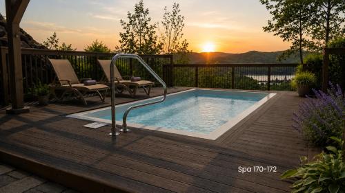 a swimming pool on a deck with the sunset in the background at Tremblant Prestige - Altitude 170-9 in Mont-Tremblant