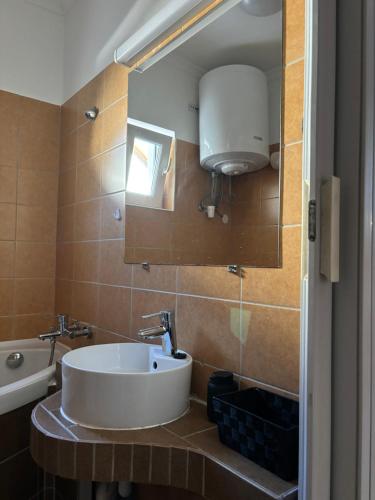 a bathroom with a white sink and a mirror at Arborétum in Harkány