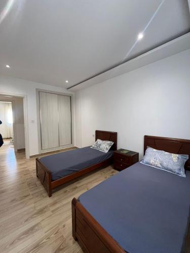 a bedroom with two beds in a room at Résidence Luna in Oran