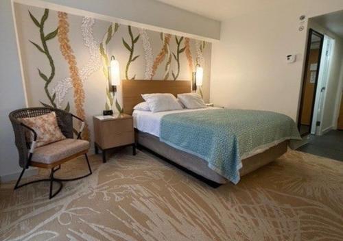 a bedroom with a bed and a chair at LSI Resorts at Ala Moana in Honolulu