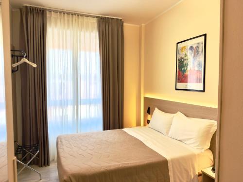 a hotel room with a bed and a window at Hotel Molise 2 in Milan