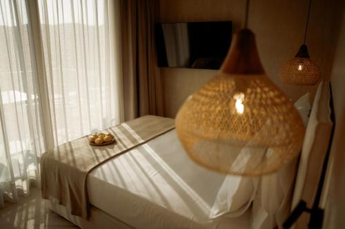 a bedroom with a bed with a large lamp on it at Manas Villas in Elaiokhórion