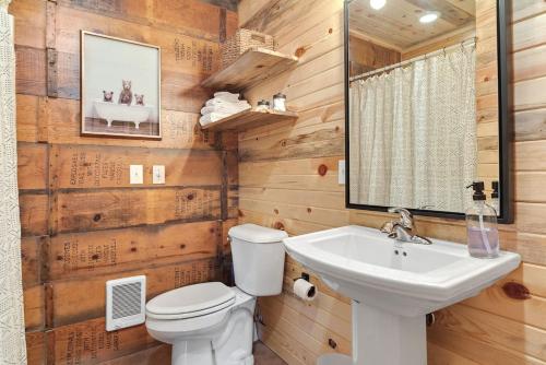 a bathroom with a white toilet and a sink at Sun Filled Joy BHBungalows #8 in Custer