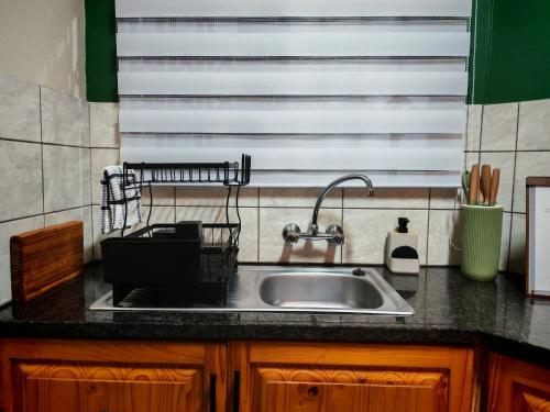 a kitchen counter with a sink and a window at The Neighborhood Haven in Richards Bay