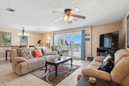 a living room with two couches and a tv at Waterfront Views & Beach Access - pet friendly in Navarre