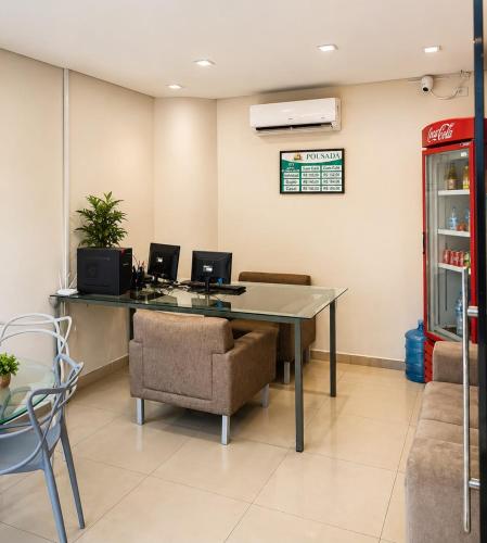 an office with a desk with two computers and a chair at Princesa do Sertão Pousada in Palmeira dos Índios