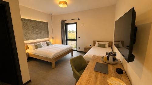 a bedroom with two beds and a table and a table sidx sidx sidx at D&C Hotel Sulingen in Sulingen