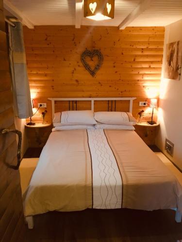 a bedroom with a large bed in a wooden room at Valley View Apartment in Kambreško